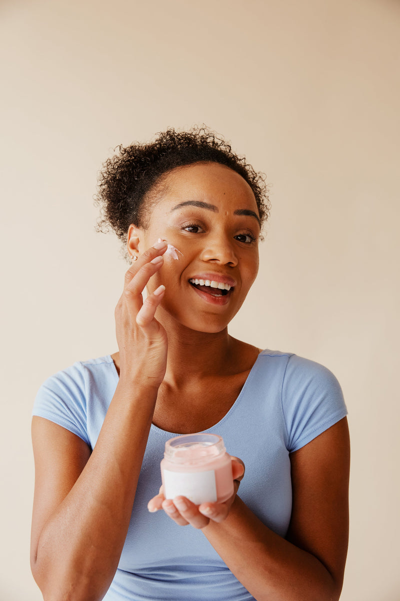 Woman applying skincare